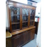 A REPRODUCTION BOOKCASE, GLAZED UPPER PORTION WITH DRAWERS AND CUPBOARDS UNDER