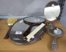 A FOUR PIECE WHITE METAL DRESSING TABLE SET, ANOTHER HAND MIRROR AND A SIMULATED TORTOISESHELL