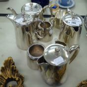 A SILVER PLATE TEA SERVICE OF FOUR PIECES AND ANOTHER OF FOUR PIECES