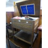 AN OAK SEWING/WORK TROLLEY WITH LIFT-UP TOP AND DRAWER BELOW AND UNDERPLATFORM AND THE CONTENTS OF