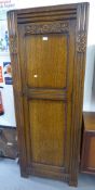 A MID TWENTIETH CENTURY OAK HALLROBE, HAVING SINGLE PANEL DOOR