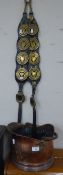 SET OF EIGHT OLD HORSE BRASSES, MOUNTED ON A PAIR OF LEATHER STRAPS AND A COPPER HELMET SHAPED