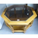 A LIGHTWOOD OCTAGONAL COFFEE TABLE WITH GLASS TOP AND SOLID UNDER SHELF