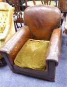 EARLY TWENTIETH CENTURY BROWN LEATHER CLUB TYPE ARMCHAIR, with carved oak feet and later green plush