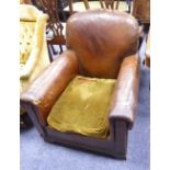 EARLY TWENTIETH CENTURY BROWN LEATHER CLUB TYPE ARMCHAIR, with carved oak feet and later green plush