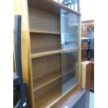 A SET OF THREE TEAK BOOKCASES, ALL WITH GLASS SLIDING DOORS, ENCLOSING THREE SHELVES (3)