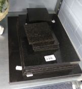 A SET OF BLACK STONE OBLONG TABLE MATS AND EIGHT MATCHING DRINKS MATS ETC..