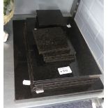 A SET OF BLACK STONE OBLONG TABLE MATS AND EIGHT MATCHING DRINKS MATS ETC..