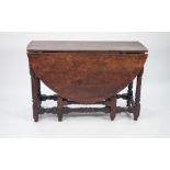 EIGHTEENTH CENTURY OAK DROP LEAF GATELEG DINING TABLE, the oval top above an end drawer with brass