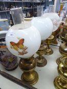 THREE EARLY/MID 20TH CENTURY BRASS OIL LAMPS WITH CLEAR GLASS FUNNELS AND TWO HAVING WHITE GLOBE