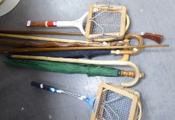 A 'WISDEN' TENNIS RACKET, TWO BADMINTON RACKETS, WALKING STICKS AND UMBRELLAS