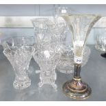 A CUT GLASS TAPERING FLOWER VASE; THREE OTHER SMALL CUT GLASS VASES; A CUT GLASS FRUIT BOWL; A GLASS