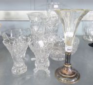 A CUT GLASS TAPERING FLOWER VASE; THREE OTHER SMALL CUT GLASS VASES; A CUT GLASS FRUIT BOWL; A GLASS