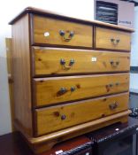 A PINE CHEST OF TWO SHORT AND TWO LONG DRAWERS AND A PINE WARDROBE WITH TWO PLANKED DOORS (2)