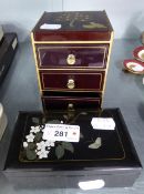 A SMALL BLACK LACQUERED NEST OF THREE JEWELLERY DRAWERS AND A SIMILAR TRINKET BOX