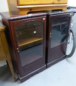 A PAIR OF MAHOGANY SMALL CABINETS, EACH ENCLOSED BY A GLAZED DOOR