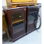 A PAIR OF MAHOGANY SMALL CABINETS, EACH ENCLOSED BY A GLAZED DOOR