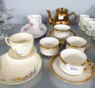 A SET OF FOUR ROYAL DOULTON FINE CHINA TEA CUPS AND SAUCERS; A CROWN DEVON 1930's TEA CUP AND