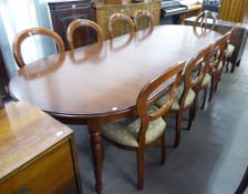 A GOOD QUALITY MAHOGANY REPRODUCTION DINING TABLE WITH TWO EXTRA LEAVES AND A SET OF TEN DINING