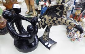 MODERN BLACK PAINTED WOODEN CARVED ABSTRACT FIGURE GROUP OF A FAMILY, AND A CARVED HORN FIGURE OF
