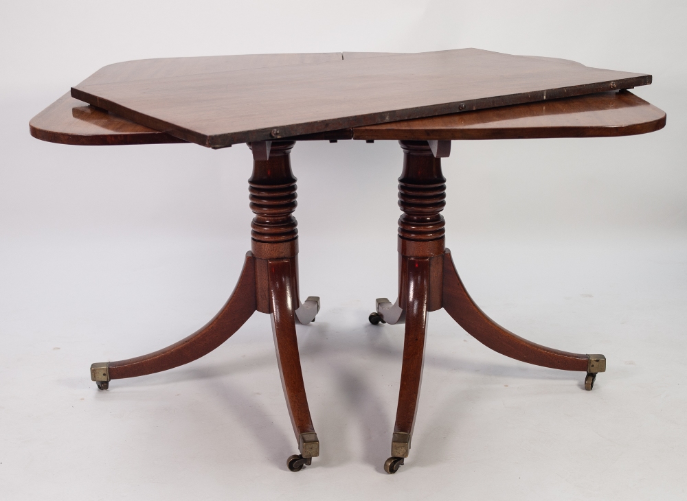 LATE GEORGIAN TWIN PILLAR MAHOGANY DINING TABLE WITH EXTRA LEAF, the rounded oblong top above a pair - Image 2 of 2