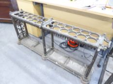 CAST IRON ORNATE UMBRELLA STAND, HAVING FOUR TRAYS AND A TWENTY FOUR HOLE COMPARTMENT