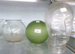 A LIFE-SIZE HOLLOW MOULDED GLASS HEAD, A GLASS FISH BOWL AND A GREEN GLASS GLOBULAR LIGHT SHADE (3)