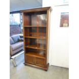 MAHOGANY TALL OPEN BOOKCASE HAVING FOUR SHELVES AND BASE CUPBOARD, STANDING ON BUN FEET, 74" (187.