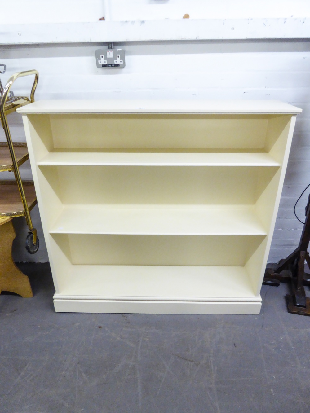 WHITE PAINTED OPEN BOOKCASE AND A SMALL BLACK METAL THREE DRAWER FILING CABINET, 26" (66.1cm)