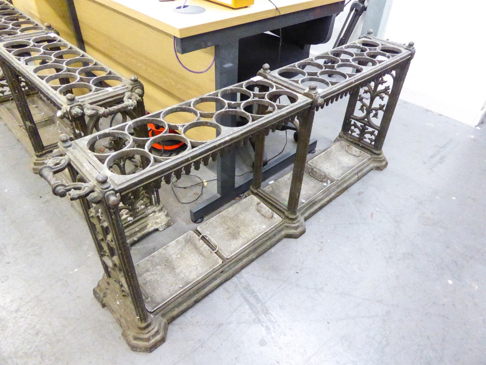 CAST IRON ORNATE UMBRELLA STAND, HAVING FOUR TRAYS AND A TWENTY FOUR HOLE COMPARTMENT