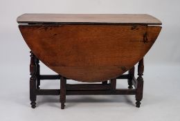 ANTIQUE OAK AND ELM DROP LEAF GATE LEG TABLE, the oval top above an end drawer fitted with brass