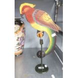 A PAINTED METAL BALANCING AND ROCKING PARROT ON STAND