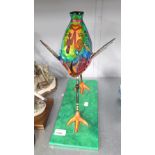 AN ORNAMENTAL PAPIER MACHE MODEL OF A BIRD, ON OBLONG BASE, 13 1/2" HIGH