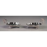 PAIR OF UNMARKED FOREIGN SILVER COLOURED METAL SMALL DISHES, each with repousse 'berry spoon'