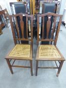 A PAIR OF EDWARDIAN MAHOGANY DINING CHAIRS WITH CENTRAL VASE SHAPED BACK SPLAT OVER CANE INSET SEATS
