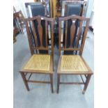 A PAIR OF EDWARDIAN MAHOGANY DINING CHAIRS WITH CENTRAL VASE SHAPED BACK SPLAT OVER CANE INSET SEATS