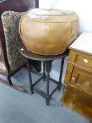 A CIRCUALR TOP OCCASIONAL TABLE RAISED ON BARLEY TWIST LEGS AND A LEATHER CIRCULAR POUFFE (2)
