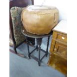 A CIRCUALR TOP OCCASIONAL TABLE RAISED ON BARLEY TWIST LEGS AND A LEATHER CIRCULAR POUFFE (2)