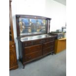 A MAHOGANY MIRROR BACK SIDEBOARD, THE BASE HAVING THREE SHORT DRAWERS WITH CARVING OVER TWO BANKS OF