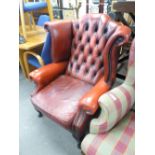 A TWENTIETH CENTURY REPRODUCTION CHESTERFIELD WINGED BACK ARMCHAIR, COVERED IN BUTTONED RED LEATHER