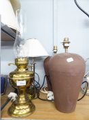 A BRASS OIL LAMP, TWO BROWN POTTERY TABLE LAMPS AND SHADES AND ANOTHER
