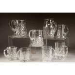 FIVE CUT GLASS JUGS, 7 ¼" (18.4cm) high and smaller, together with THREE CUT GLASS MUGS, 5 ½" (14cm)