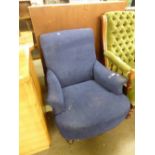 A VICTORIAN LOW ARMCHAIR, ON TURNED FRONT SUPPORTS, COVERED IN BLUE FABRIC