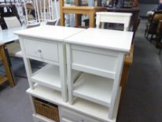 A PAIR OF WHITE FINISH TWO TIER SQUARE LAMP TABLES, EACH WITH A DRAWER AND ANOTHER SMALL WHITE