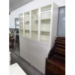 TWO MODERN WHITE ENAMELLED FINISH TALL DISPLAY CABINET EACH WITH TWO GLAZED DOORS, 2'6" WIDE
