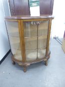 A DEMI-LUNE DISPLAY CABINET, RAISED ON CABRIOLE SUPPORTS