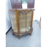 A DEMI-LUNE DISPLAY CABINET, RAISED ON CABRIOLE SUPPORTS