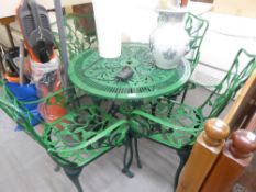 A GREEN CAST AND PIERCED METAL CIRCULAR GARDEN TABLE AND FOUR MATCHING ARMCHAIRS (5)