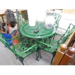 A GREEN CAST AND PIERCED METAL CIRCULAR GARDEN TABLE AND FOUR MATCHING ARMCHAIRS (5)