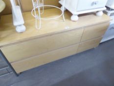 A MODERN LIGHT WOOD EFFECT LOW CHEST OF TWO LONG AND TWO SHORT DRAWERS